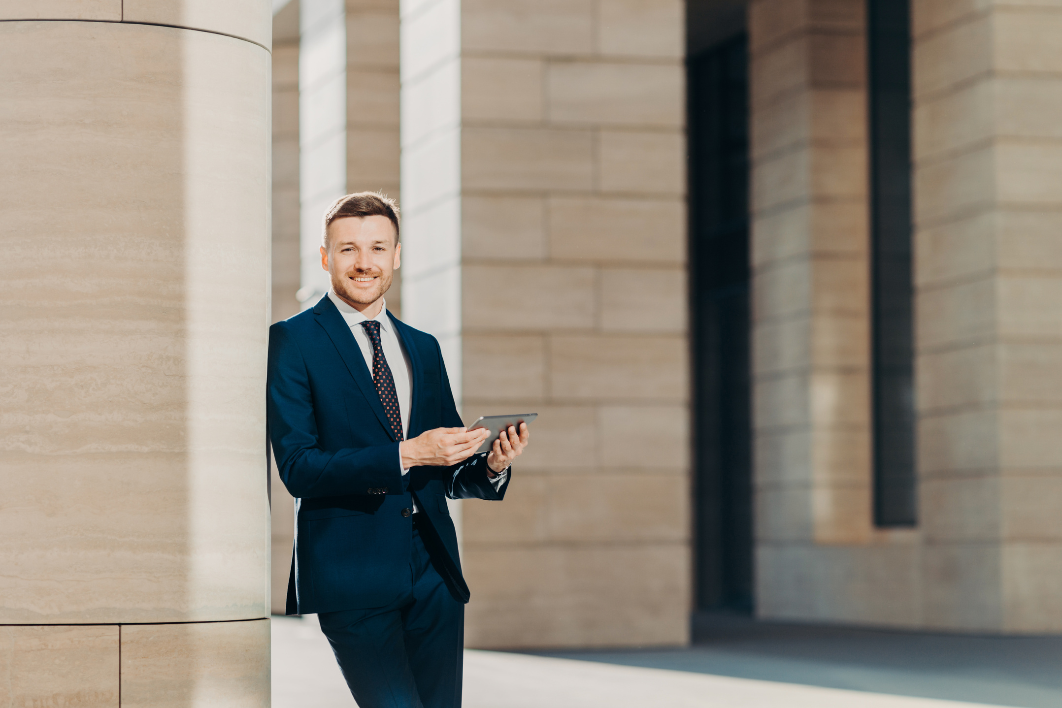 Young Businessman Holding Smart Tablet