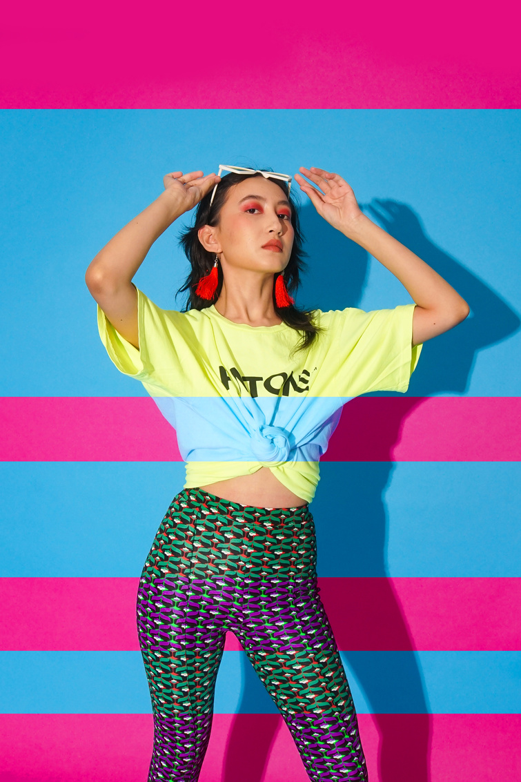 Woman in Bold Retro Outfit against Blue and Pink Background