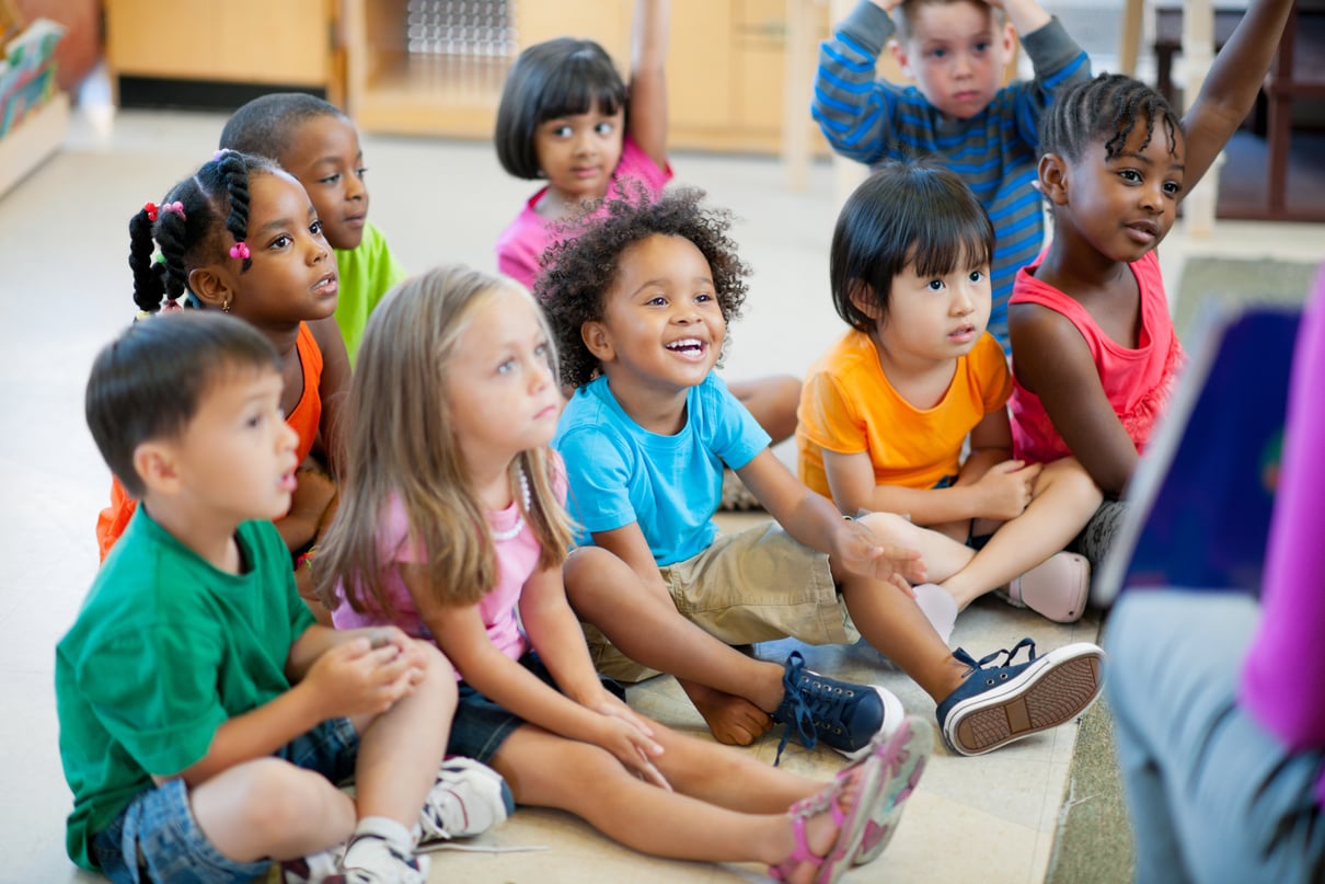 Young kids listening to teacher